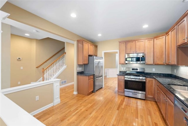 156 Hampton Way S, Kingstown, RI 02879 - kitchen with appliances with stainless steel finishes, light wood finished floors, backsplash, dark stone countertops, and recessed lighting