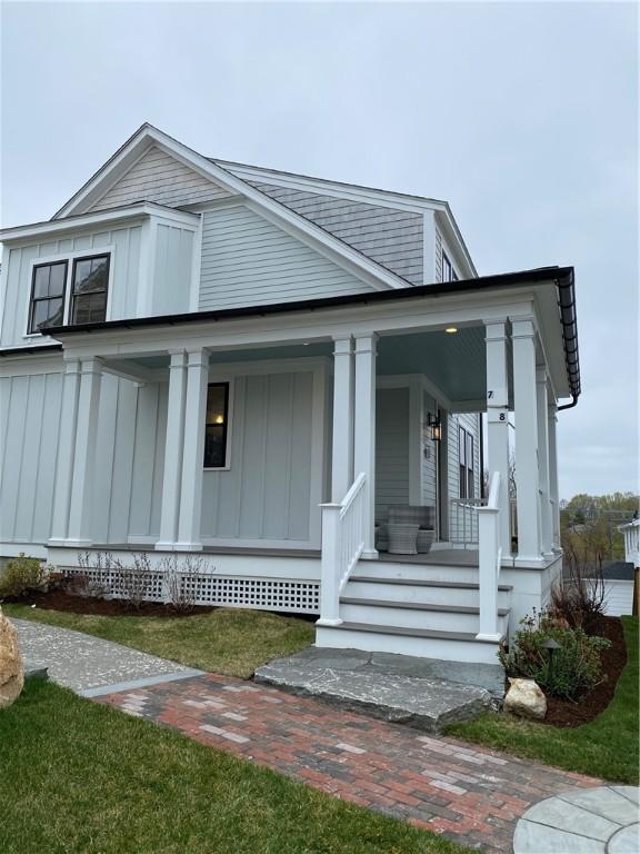 15 Castle St Unit 7, East Greenwich, RI 02818 - view of front of home with covered porch and board and batten siding