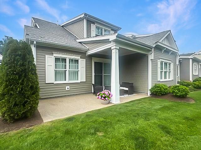 23 Middleberry Ln, East Greenwich, RI 02818 - back of house featuring a patio, a yard, and roof with shingles