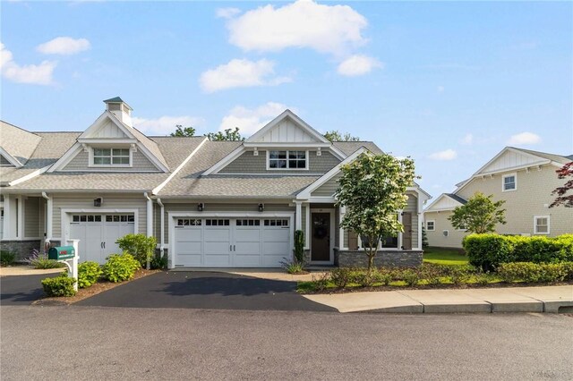 23 Middleberry Ln, East Greenwich, RI 02818 - view of front of house featuring asphalt driveway, an attached garage, stone siding, and roof with shingles