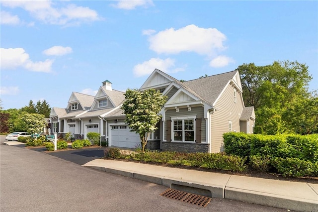 23 Middleberry Ln, East Greenwich, RI 02818 - view of front of house with driveway, board and batten siding, and an attached garage
