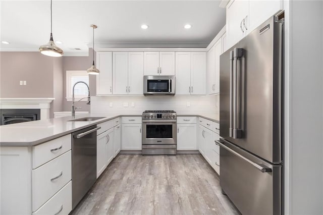 23 Middleberry Ln, East Greenwich, RI 02818 - kitchen with appliances with stainless steel finishes, a peninsula, white cabinets, backsplash, and recessed lighting