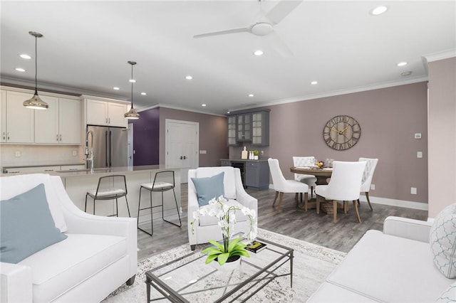 23 Middleberry Ln, East Greenwich, RI 02818 - living room featuring ornamental molding, recessed lighting, light wood-type flooring, a ceiling fan, and beverage cooler