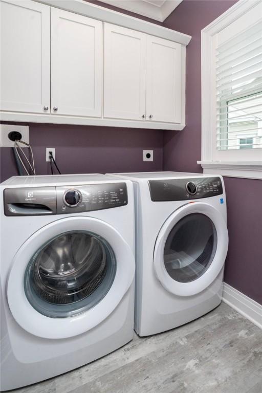 23 Middleberry Ln, East Greenwich, RI 02818 - washroom featuring cabinet space, washing machine and clothes dryer, and wood finished floors