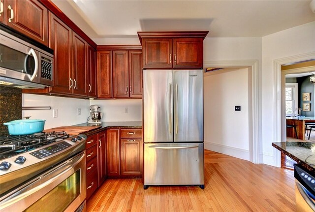 384 Benefit St Unit 2, Providence, RI 02903 - kitchen with stainless steel appliances, light wood-style flooring, and reddish brown cabinets