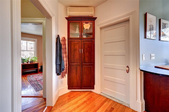 384 Benefit St Unit 2, Providence, RI 02903 - entrance foyer with light wood-type flooring and a wall unit AC
