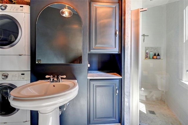 384 Benefit St Unit 2, Providence, RI 02903 - bathroom with stacked washer / dryer, a stall shower, and a sink