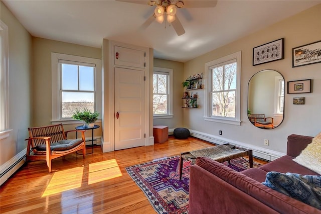 384 Benefit St Unit 2, Providence, RI 02903 - living area featuring ceiling fan, a baseboard heating unit, light wood finished floors, and baseboards