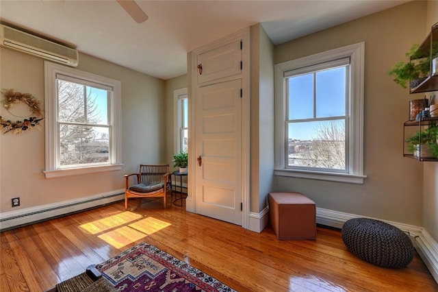 384 Benefit St Unit 2, Providence, RI 02903 - entrance foyer with a wall mounted air conditioner, a baseboard heating unit, light wood finished floors, a ceiling fan, and baseboards