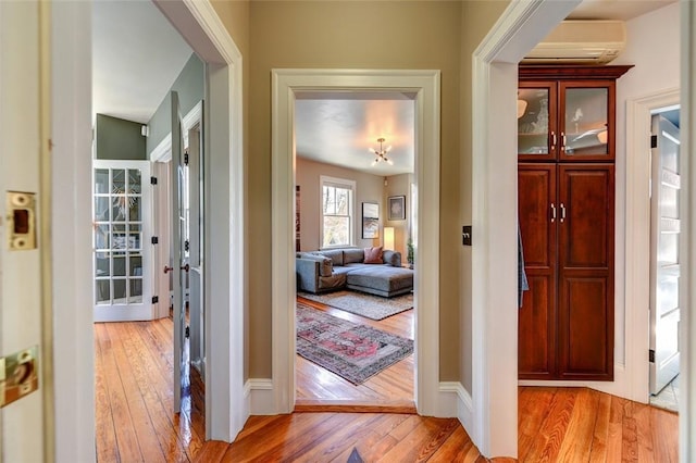 384 Benefit St Unit 2, Providence, RI 02903 - foyer with a wall mounted AC, light wood-style flooring, and baseboards