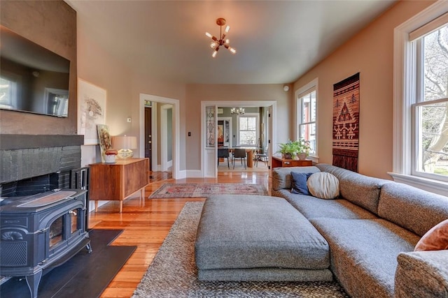 384 Benefit St Unit 2, Providence, RI 02903 - living area featuring a chandelier, healthy amount of natural light, and a wood stove