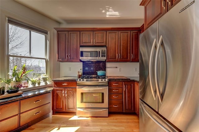 384 Benefit St Unit 2, Providence, RI 02903 - kitchen featuring stainless steel appliances, light wood finished floors, and dark stone counters