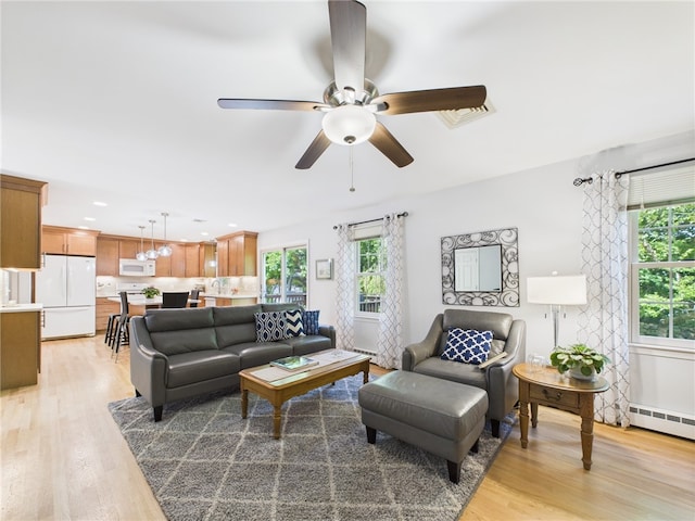 64 E Park Ln, South Kingstown, RI 02879 - living area featuring light wood-style flooring, a ceiling fan, and baseboard heating