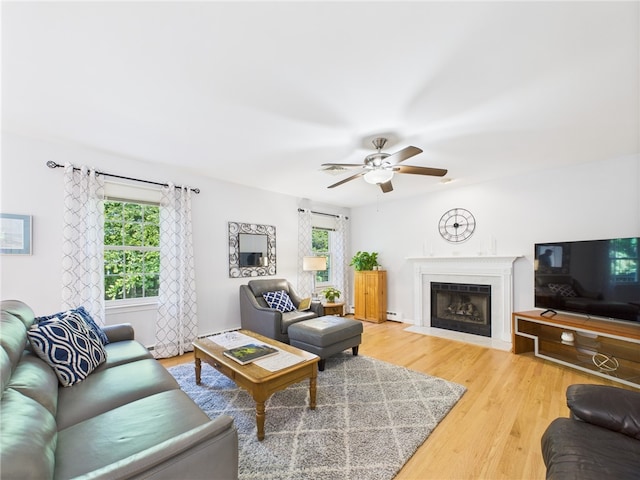 64 E Park Ln, South Kingstown, RI 02879 - living area featuring a ceiling fan, light wood-style floors, and a fireplace with flush hearth