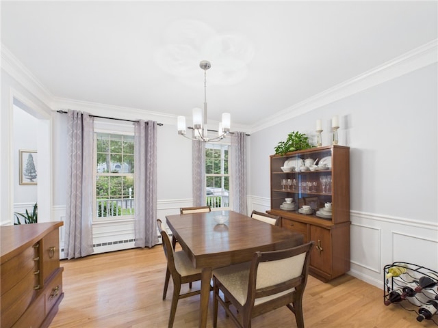 64 E Park Ln, South Kingstown, RI 02879 - dining space with a chandelier, crown molding, light wood finished floors, wainscoting, and a decorative wall