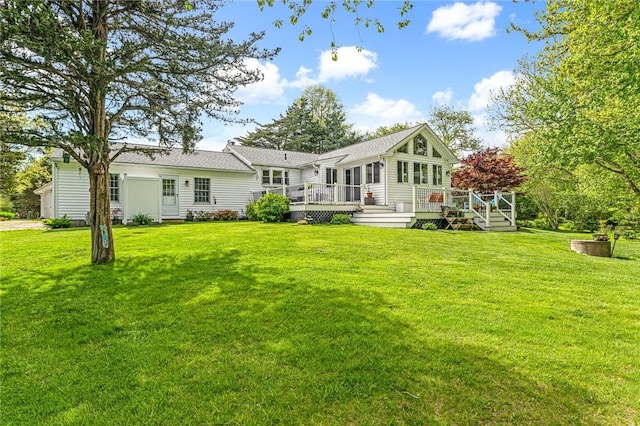 22 Pond View Dr, Little Compton, RI 02837 - rear view of property with a wooden deck and a lawn