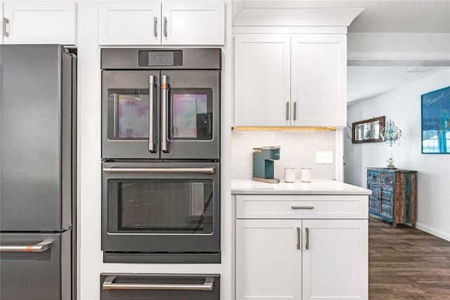 22 Pond View Dr, Little Compton, RI 02837 - kitchen with freestanding refrigerator, double oven, dark wood-style floors, and white cabinets