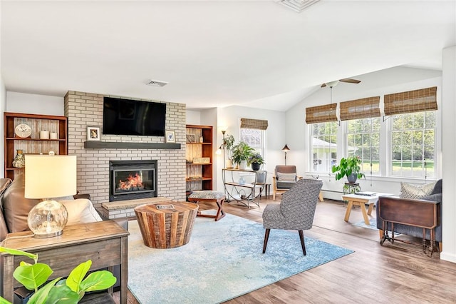 22 Pond View Dr, Little Compton, RI 02837 - living room with a brick fireplace, ceiling fan, wood finished floors, and vaulted ceiling