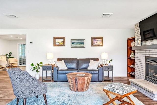22 Pond View Dr, Little Compton, RI 02837 - living area with a brick fireplace and wood finished floors