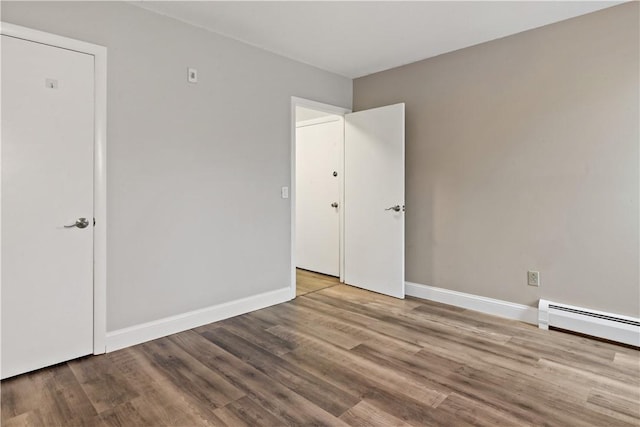 3940 Post Rd Unit 38, Warwick, RI 02886 - spare room with wood finished floors, baseboards, and a baseboard heating unit