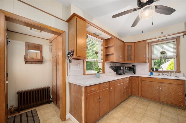 66 Dean Ave, Smithfield, RI 02917 - kitchen with radiator heating unit, light countertops, brown cabinets, and backsplash