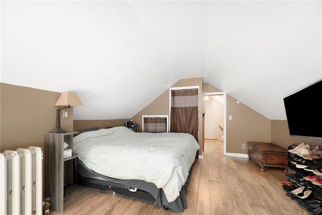 66 Dean Ave, Smithfield, RI 02917 - bedroom with radiator, light wood finished floors, and vaulted ceiling
