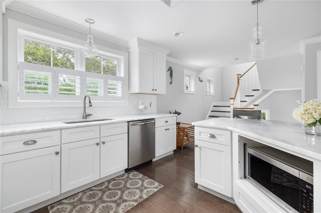 36 Wanda St, Narragansett, RI 02882 - kitchen with stainless steel appliances, a sink, decorative backsplash, pendant lighting, and ornamental molding