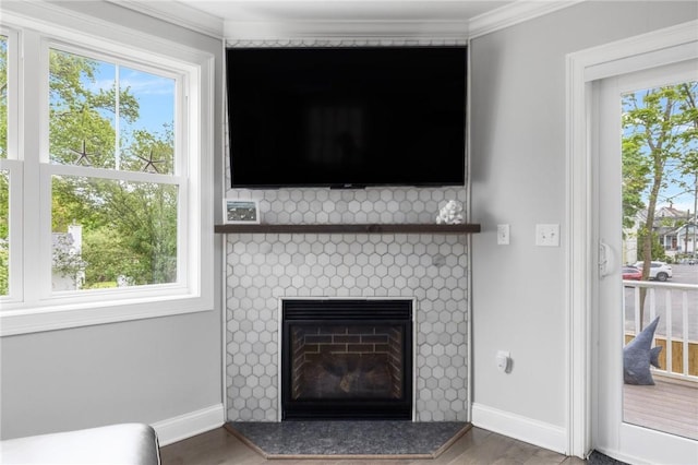 36 Wanda St, Narragansett, RI 02882 - detailed view of wood finished floors, crown molding, baseboards, and a tile fireplace
