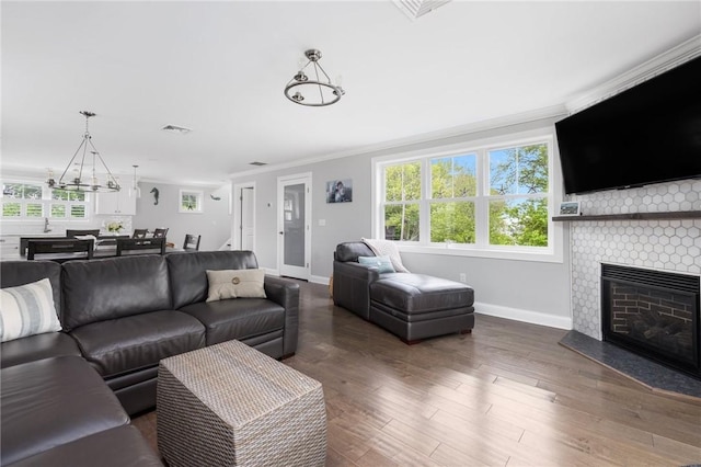 36 Wanda St, Narragansett, RI 02882 - living area with crown molding, a chandelier, baseboards, plenty of natural light, and a large fireplace