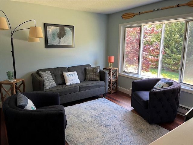 12 Mautucket Rd, South Kingstown, RI 02879 - living area with wood finished floors, baseboards, and a baseboard radiator
