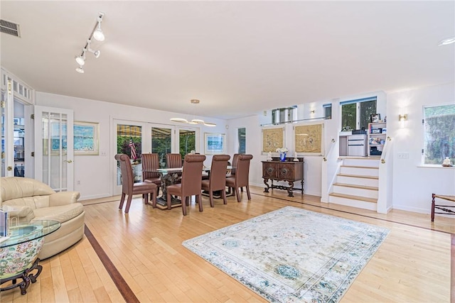 48 Wright Ln, Jamestown, RI 02835 - living room featuring light wood-style flooring, a chandelier, track lighting, and baseboards