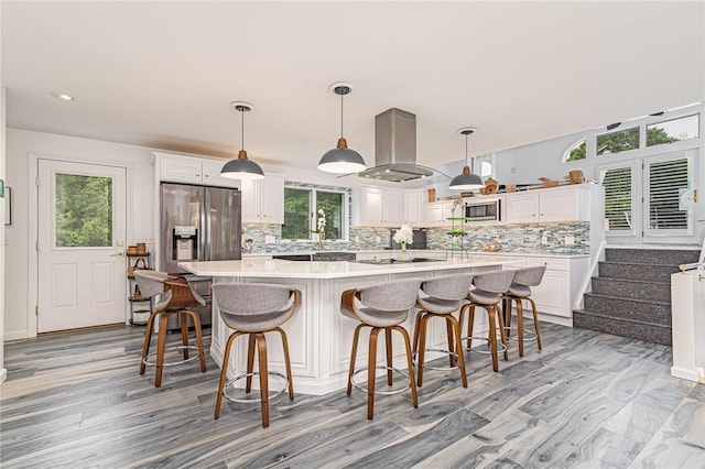 48 Wright Ln, Jamestown, RI 02835 - kitchen featuring appliances with stainless steel finishes, island range hood, tasteful backsplash, white cabinets, and recessed lighting