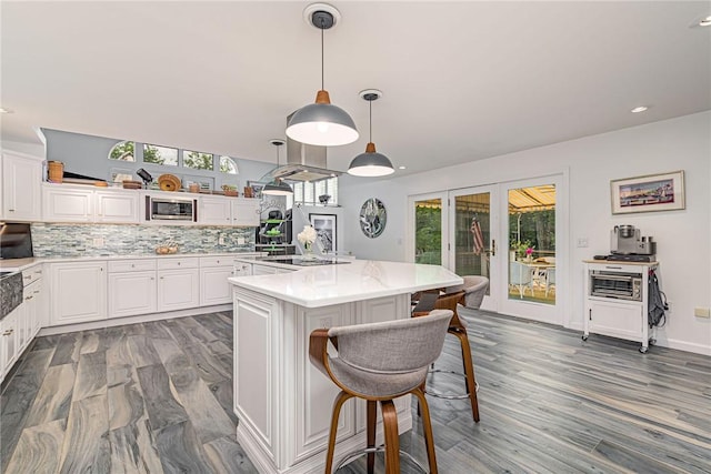 48 Wright Ln, Jamestown, RI 02835 - kitchen with healthy amount of natural light, light countertops, decorative backsplash, white cabinets, and recessed lighting