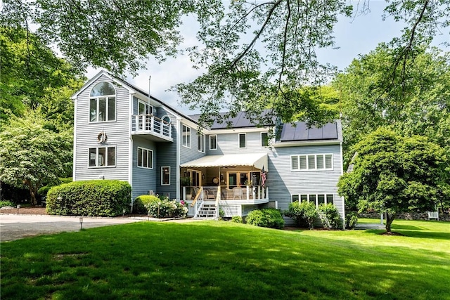 48 Wright Ln, Jamestown, RI 02835 - view of front of property with a front yard, solar panels, and covered porch