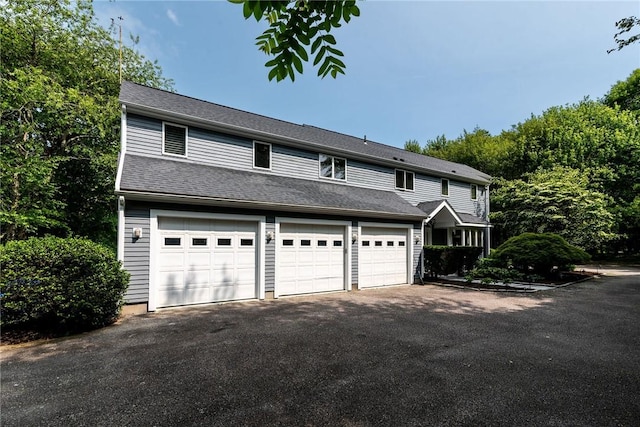 48 Wright Ln, Jamestown, RI 02835 - view of front of house with driveway and a garage