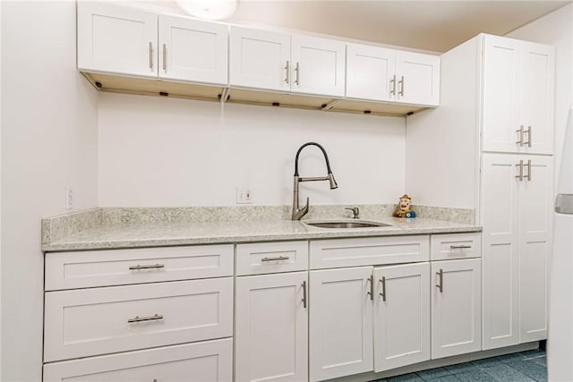 48 Wright Ln, Jamestown, RI 02835 - kitchen featuring a sink, white cabinets, light stone counters, and tile patterned floors