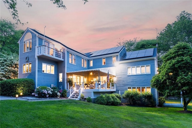 48 Wright Ln, Jamestown, RI 02835 - back of house featuring solar panels, a lawn, and a balcony