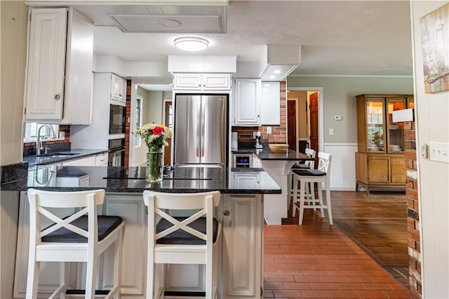 850 Black Plain Rd, North Smithfield, RI 02896 - kitchen with black appliances, a peninsula, a sink, brick floors, and a wainscoted wall