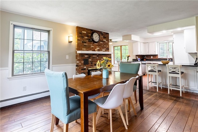 850 Black Plain Rd, North Smithfield, RI 02896 - dining space with baseboard heating, dark wood finished floors, and a wainscoted wall