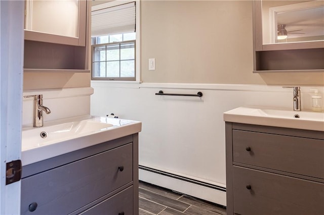 850 Black Plain Rd, North Smithfield, RI 02896 - bathroom featuring a baseboard heating unit, vanity, and wood finished floors