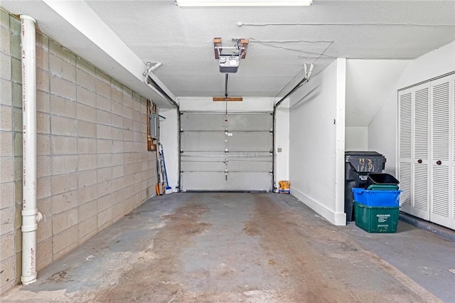 565 Quaker Ln Unit 43, West Warwick, RI 02893 - garage featuring a garage door opener and concrete block wall