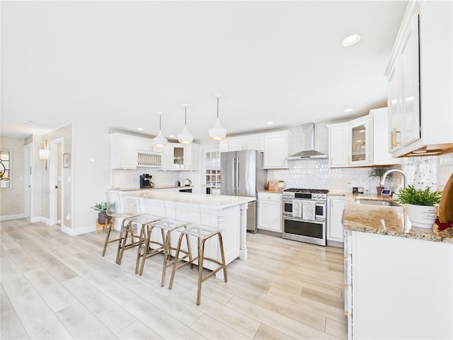6 Dolphin Rd, Narragansett, RI 02882 - kitchen with appliances with stainless steel finishes, wall chimney range hood, a sink, backsplash, and recessed lighting