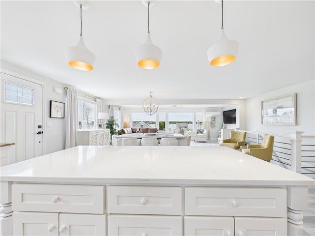 6 Dolphin Rd, Narragansett, RI 02882 - kitchen with open floor plan, white cabinets, and decorative light fixtures
