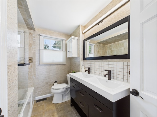 6 Dolphin Rd, Narragansett, RI 02882 - bathroom with double vanity, toilet, tile walls, and tile patterned flooring