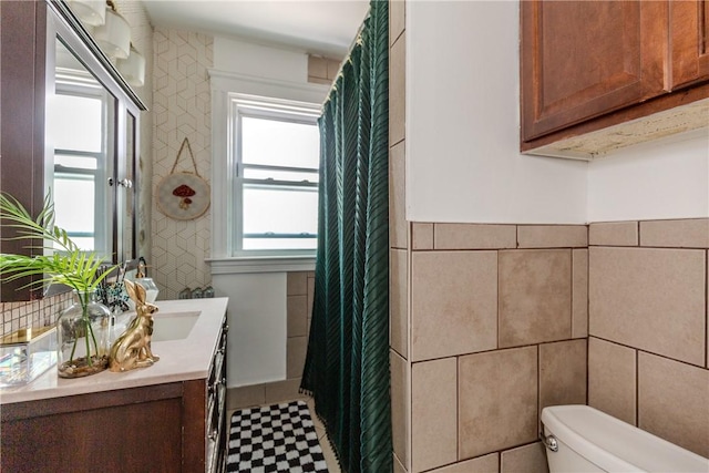 412 E Ave, Pawtucket, RI 02860 - bathroom with tile walls, vanity, toilet, tile patterned floors, and a shower with shower curtain