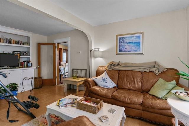 99 Third St, West Warwick, RI 02893 - living area featuring arched walkways, wood finished floors, and built in shelves