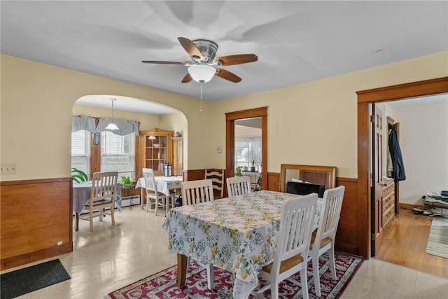 99 Third St, West Warwick, RI 02893 - dining area with a wainscoted wall, a ceiling fan, and arched walkways