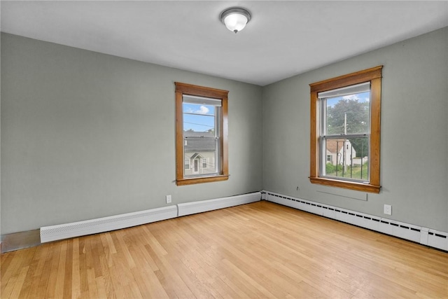 99 Third St, West Warwick, RI 02893 - empty room featuring wood finished floors, baseboards, and a baseboard radiator