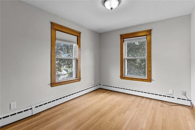 99 Third St, West Warwick, RI 02893 - unfurnished room featuring wood finished floors and a baseboard heating unit