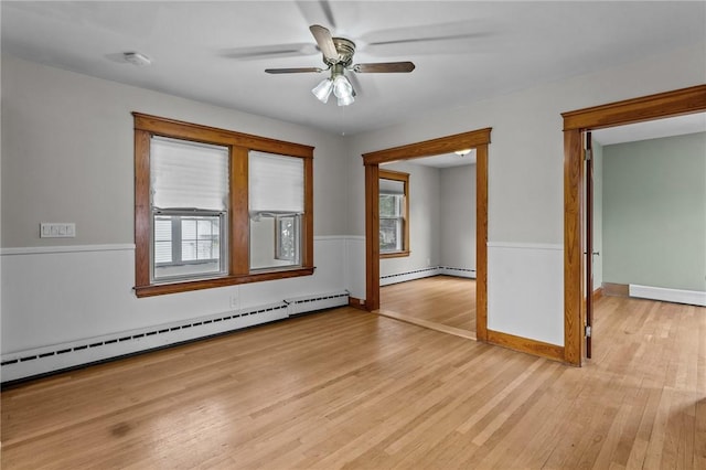 99 Third St, West Warwick, RI 02893 - spare room featuring baseboard heating, light wood-type flooring, a ceiling fan, a smoke detector, and baseboards